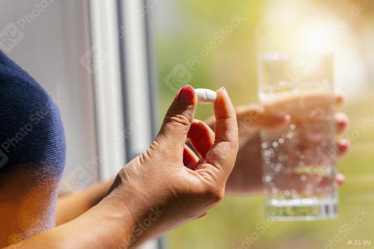 one round white pill in young female hand. Woman takes medicines with glass of water. Daily norm of vitamins, effective drugs, pharmacy and mental health concept image  : Stock Photo or Stock Video Download rcfotostock photos, images and assets rcfotostock | RC Photo Stock.: