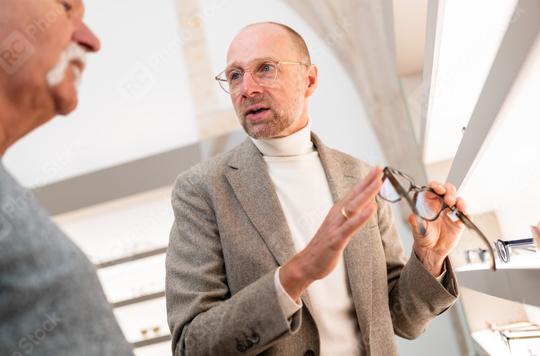 Optician discussing eyeglasses with senior male client in store. He is pointing at glasses.  : Stock Photo or Stock Video Download rcfotostock photos, images and assets rcfotostock | RC Photo Stock.: