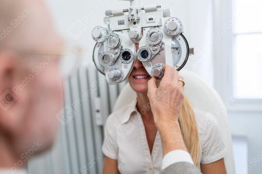 Optometrist adjusting a phoropter for a female patient during an  : Stock Photo or Stock Video Download rcfotostock photos, images and assets rcfotostock | RC Photo Stock.: