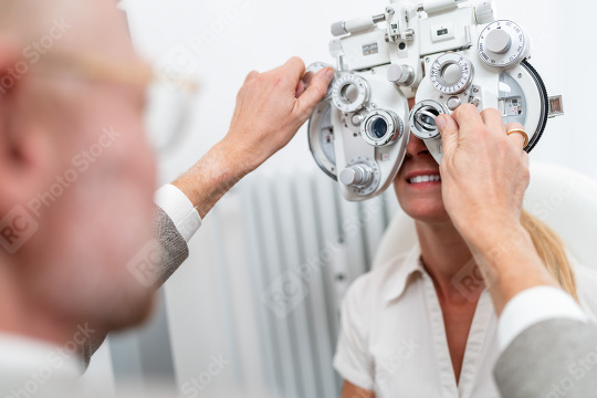 Optometrist conducting a refraction test with a phoropter on a f  : Stock Photo or Stock Video Download rcfotostock photos, images and assets rcfotostock | RC Photo Stock.: