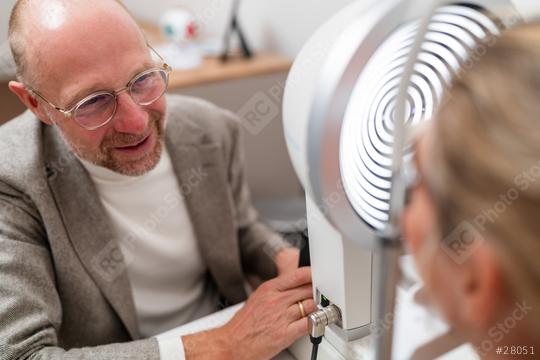 Optometrist engaging with a young patient and during an eye exam with a keratograph at the ophthalmology clinic. Close-up photo. Healthcare and medicine concept  : Stock Photo or Stock Video Download rcfotostock photos, images and assets rcfotostock | RC Photo Stock.: