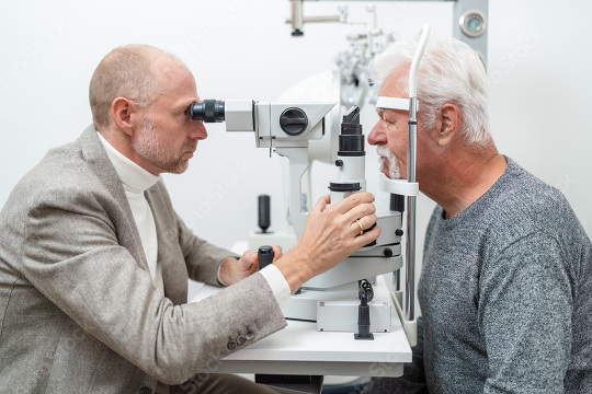 Optometrist examining the eyes of a senior male patient using a   : Stock Photo or Stock Video Download rcfotostock photos, images and assets rcfotostock | RC Photo Stock.: