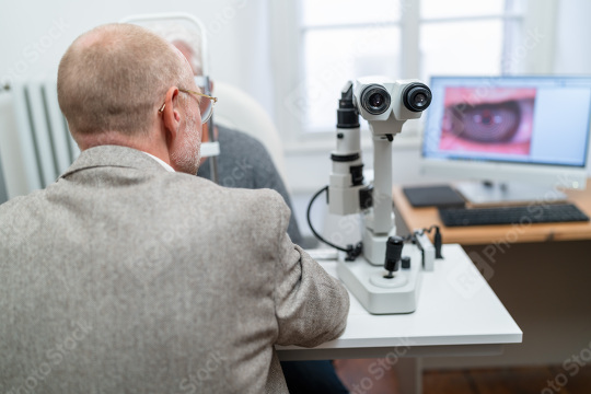 Optometrist looking through Keratograph during an eye examinatio  : Stock Photo or Stock Video Download rcfotostock photos, images and assets rcfotostock | RC Photo Stock.: