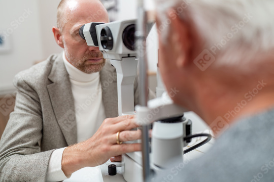 Optometrist using specialized equipment slit-lamp to examine an   : Stock Photo or Stock Video Download rcfotostock photos, images and assets rcfotostock | RC Photo Stock.: