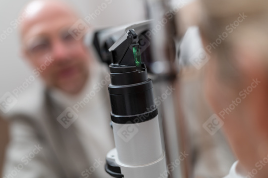 Optometry equipment slit lamp in focus with patient and optometr  : Stock Photo or Stock Video Download rcfotostock photos, images and assets rcfotostock | RC Photo Stock.: