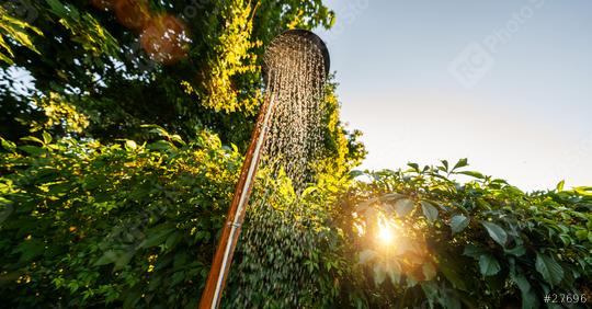 Outdoor shower at sunset for showering body before jumping in the resort pool. Golden Hour Refreshment Spa wellness concept image  : Stock Photo or Stock Video Download rcfotostock photos, images and assets rcfotostock | RC Photo Stock.: