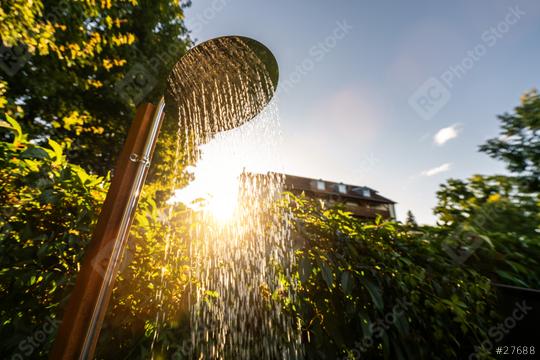 Outdoor shower sprinkler in the garden for swimming in the resort pool at sunrise. Golden Hour Refreshment Spa wellness concept image  : Stock Photo or Stock Video Download rcfotostock photos, images and assets rcfotostock | RC Photo Stock.: