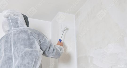 painter stands with paint roller on a ladder to paint the corner of a room window with white color. do it yourself concept image  : Stock Photo or Stock Video Download rcfotostock photos, images and assets rcfotostock | RC Photo Stock.: