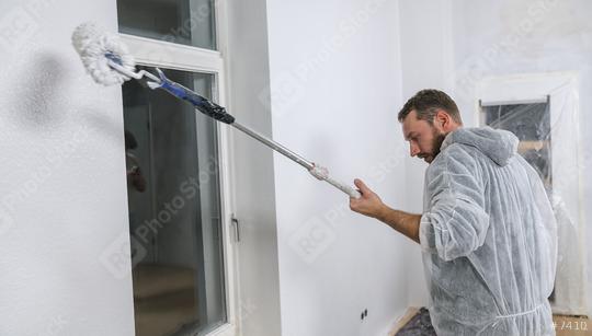 painter working with paint roller in a room to paint white color on a wall. do it yourself concept image  : Stock Photo or Stock Video Download rcfotostock photos, images and assets rcfotostock | RC Photo Stock.: