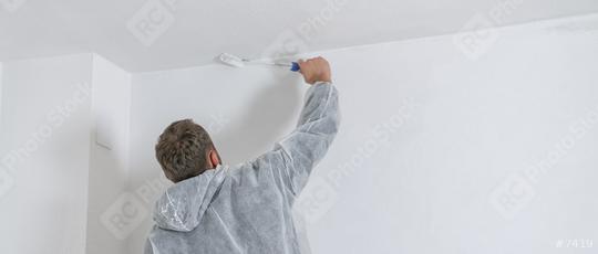 painter working with paint roller to paint the ceiling of a room with white color  : Stock Photo or Stock Video Download rcfotostock photos, images and assets rcfotostock | RC Photo Stock.:
