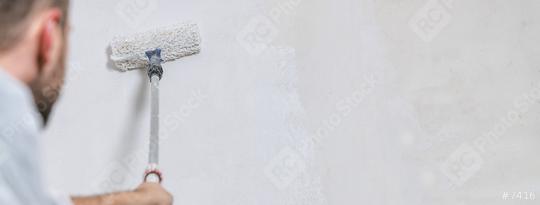 painter working with paint roller to paint the wall of a room. do it yourself concept image with copy space  : Stock Photo or Stock Video Download rcfotostock photos, images and assets rcfotostock | RC Photo Stock.: