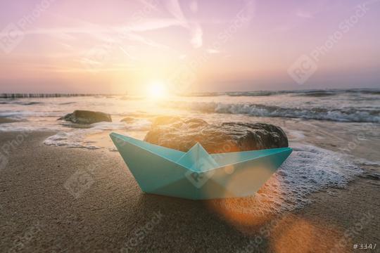 paper boat sailing on at the beach at a romantic sunset  : Stock Photo or Stock Video Download rcfotostock photos, images and assets rcfotostock | RC Photo Stock.: