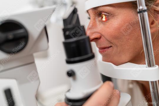 Patient undergoing an eye examination with a focus on her illuminated eye using a slit lamp at the clinic. Close-up photo. Healthcare and medicine concept  : Stock Photo or Stock Video Download rcfotostock photos, images and assets rcfotostock | RC Photo Stock.: