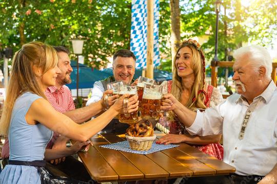 people in proper Tracht toasting and drinking in Bavarian beer garden at Oktoberfest, folk or beer festival in germany   : Stock Photo or Stock Video Download rcfotostock photos, images and assets rcfotostock | RC Photo Stock.: