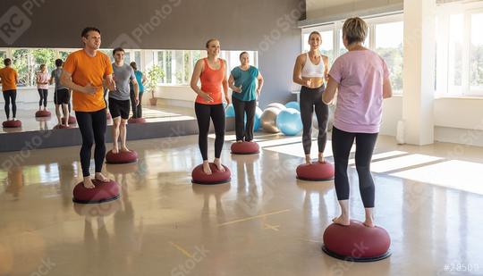 People training balance on Bosu Balls during a group fitness session in a gym  : Stock Photo or Stock Video Download rcfotostock photos, images and assets rcfotostock | RC Photo Stock.: