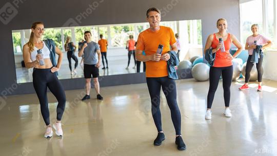 People with gym equipment smiling in a fitness center, exercise balls in the background. Teamwork Concept image  : Stock Photo or Stock Video Download rcfotostock photos, images and assets rcfotostock | RC Photo Stock.: