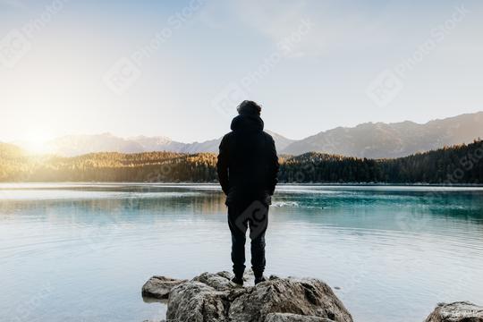Person from behind looks at beautiful lake at sunrise.
Relaxed, peaceful, thoughtful, happy and free at the mountain lake.  : Stock Photo or Stock Video Download rcfotostock photos, images and assets rcfotostock | RC Photo Stock.: