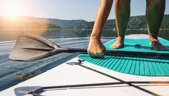 Person on paddle board tries to stand up  : Stock Photo or Stock Video Download rcfotostock photos, images and assets rcfotostock | RC Photo Stock.: