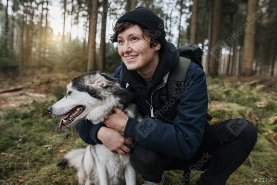 Person with a cute white-black husky dog in the forest with sunset. Outdoor autumn mood. Enjoy life and lovely friendship with with a pet.   : Stock Photo or Stock Video Download rcfotostock photos, images and assets rcfotostock | RC Photo Stock.:
