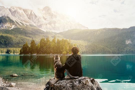 person with a dog in the mountains at a beautiful lake at sunset. Traveling with a pet. Happy satisfied time together. Friendship between man woman and dog. hugs.   : Stock Photo or Stock Video Download rcfotostock photos, images and assets rcfotostock | RC Photo Stock.: