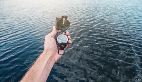 Point of view shot. Traveler man searching direction with a compass at the sea.   : Stock Photo or Stock Video Download rcfotostock photos, images and assets rcfotostock | RC Photo Stock.: