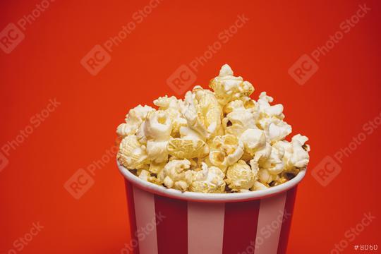 Popcorn in a round box and around on a bright red background.  : Stock Photo or Stock Video Download rcfotostock photos, images and assets rcfotostock | RC Photo Stock.: