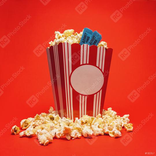 Popcorn with cinema tickets in a large square box and around on a bright red background.  : Stock Photo or Stock Video Download rcfotostock photos, images and assets rcfotostock | RC Photo Stock.: