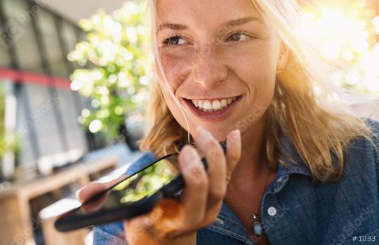 Portrait of a girl using the voice recognition of the phone sitting in a trendy cosy coffee shop cafe  : Stock Photo or Stock Video Download rcfotostock photos, images and assets rcfotostock | RC Photo Stock.: