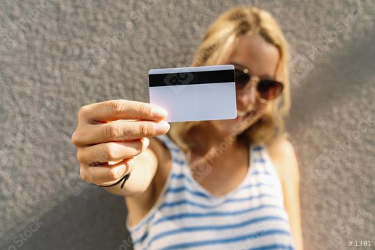 Portrait of a pretty young woman dressed in sweater holding credit card at her face. copyspace for your individual text.   : Stock Photo or Stock Video Download rcfotostock photos, images and assets rcfotostock | RC Photo Stock.: