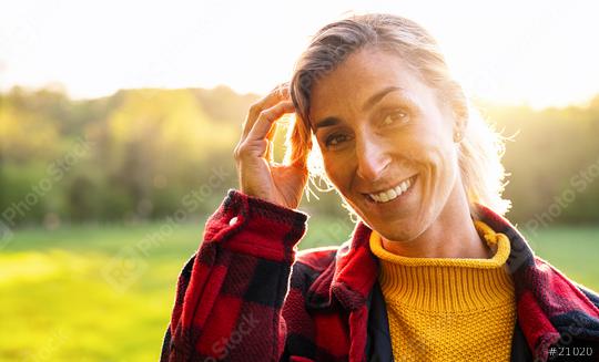 Portrait of beautiful mature woman smiling and looking away at park during sunset. Outdoor portrait of a smiling girl. Happy cheerful girl laughing at park with checkered shirt.  : Stock Photo or Stock Video Download rcfotostock photos, images and assets rcfotostock | RC Photo Stock.: