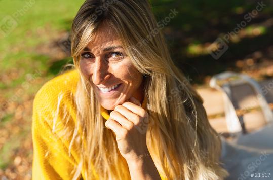 Portrait of beautiful woman sitting in a city park. Happy smiling woman sitting on a bench outdoor at summer looking at camera. Portrait of carefree woman relaxing on bench.  : Stock Photo or Stock Video Download rcfotostock photos, images and assets rcfotostock | RC Photo Stock.: