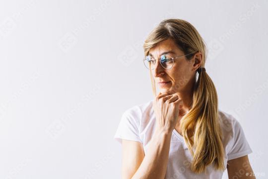 portrait of young woman thinking looks left hand on chin, thinking positive, with copyspace for text  : Stock Photo or Stock Video Download rcfotostock photos, images and assets rcfotostock | RC Photo Stock.: