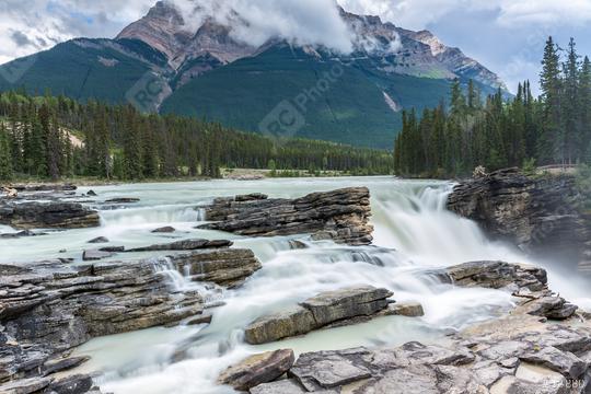 Powerful picturesque waterfall Athabasca. Pyramidal mountain covered with the first snow. Canada, Jasper National Park  : Stock Photo or Stock Video Download rcfotostock photos, images and assets rcfotostock | RC Photo Stock.: