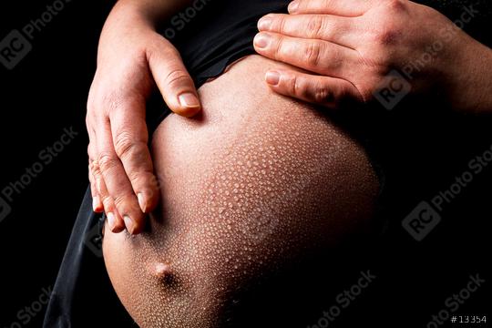 Pregnant woman caressing her belly with drops of water  : Stock Photo or Stock Video Download rcfotostock photos, images and assets rcfotostock | RC-Photo-Stock.:
