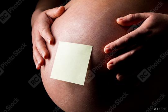 Pregnant woman caressing her belly with Sticky Note  : Stock Photo or Stock Video Download rcfotostock photos, images and assets rcfotostock | RC Photo Stock.: