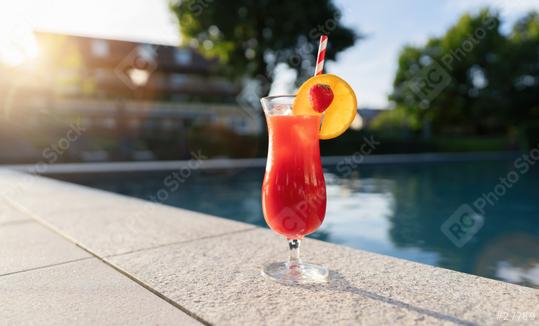 refreshing red cocktail garnished with a strawberry and orange slice by a poolside at sunset  : Stock Photo or Stock Video Download rcfotostock photos, images and assets rcfotostock | RC Photo Stock.: