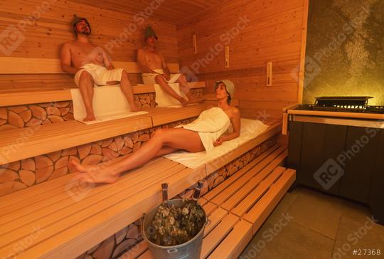 Relaxed individuals in a finnish sauna, two men sitting with felt hats and a woman lying down with a bucket and vihta on the bench  : Stock Photo or Stock Video Download rcfotostock photos, images and assets rcfotostock | RC Photo Stock.: