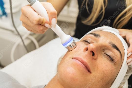 relaxed woman lying on the medical bed with her eyes closed while having hydrafacial clean procedure at a cosmetology salon.  : Stock Photo or Stock Video Download rcfotostock photos, images and assets rcfotostock | RC Photo Stock.: