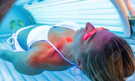 relaxing woman tanning in solarium with glasses  : Stock Photo or Stock Video Download rcfotostock photos, images and assets rcfotostock | RC Photo Stock.: