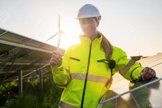 Renewable energy technician holding a wind turbine model at solar farm. Alternative energy ecological concept image.  : Stock Photo or Stock Video Download rcfotostock photos, images and assets rcfotostock | RC Photo Stock.: