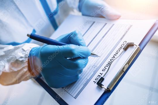 Researcher fills out a coronavirus test data sheet with pen in protective clothing in a clinic at Covid-19 coronavirus epidemic  : Stock Photo or Stock Video Download rcfotostock photos, images and assets rcfotostock | RC Photo Stock.: