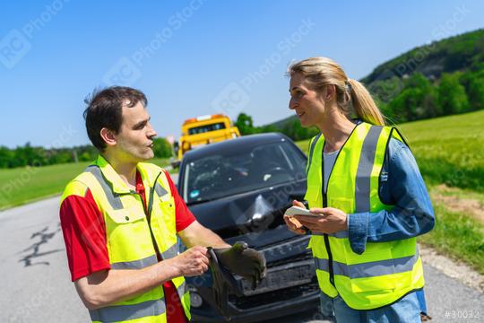 Roadside assistance worker and customer discuss what to do next after an accident beside a towed car and tow truck in the background  : Stock Photo or Stock Video Download rcfotostock photos, images and assets rcfotostock | RC Photo Stock.:
