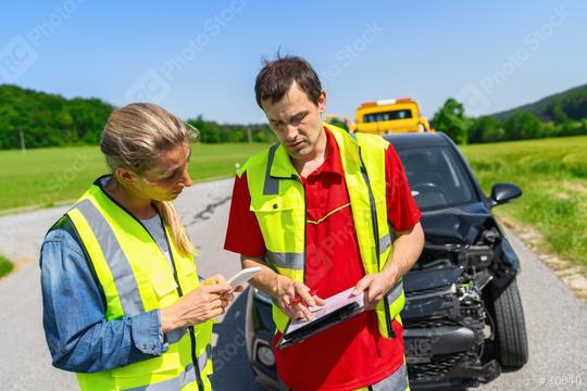 Roadside assistance worker filling out paperwork on a clipboard with customer against backdrop of tow truck and damaged car  : Stock Photo or Stock Video Download rcfotostock photos, images and assets rcfotostock | RC Photo Stock.:
