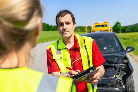 Roadside assistance worker holding clipboard discussing with woman in safety vest after car accident about the further course  : Stock Photo or Stock Video Download rcfotostock photos, images and assets rcfotostock | RC Photo Stock.: