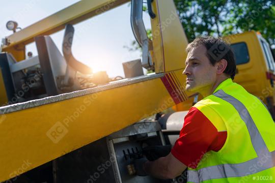 Roadside service professional worker operating machinery lift on a tow truck.  : Stock Photo or Stock Video Download rcfotostock photos, images and assets rcfotostock | RC Photo Stock.: