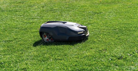 Robotic lawn mower mows the lawn in a garden  : Stock Photo or Stock Video Download rcfotostock photos, images and assets rcfotostock | RC Photo Stock.: