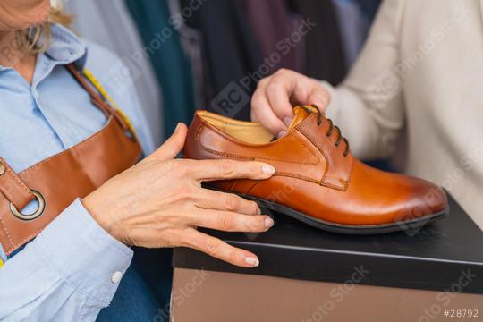 Saleswoman presenting wedding shoes to a customer  : Stock Photo or Stock Video Download rcfotostock photos, images and assets rcfotostock | RC Photo Stock.: