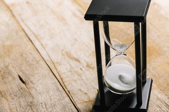 Sand running through the bulbs of an hourglass measuring the passing time in a countdown to a deadline, on a wooden background with copy space  : Stock Photo or Stock Video Download rcfotostock photos, images and assets rcfotostock | RC Photo Stock.: