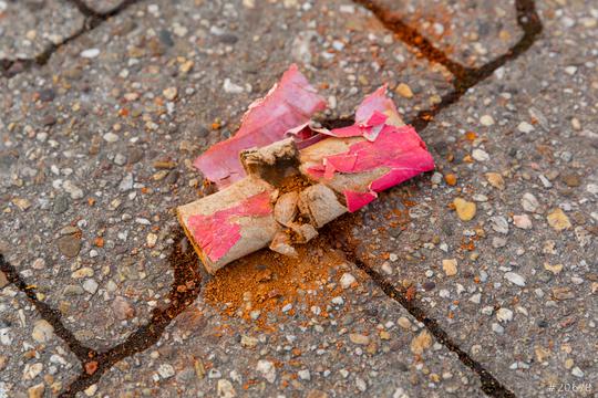 Scattered pieces of a firecracker are spread on the ground.  : Stock Photo or Stock Video Download rcfotostock photos, images and assets rcfotostock | RC Photo Stock.: