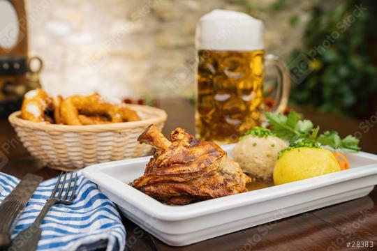 Schweinshaxe, traditional Bavarian cuisine with roasted ham hock (pork knuckle) with potato dumpling, brezen and beer mug in a beer garden or oktoberfest  : Stock Photo or Stock Video Download rcfotostock photos, images and assets rcfotostock | RC Photo Stock.: